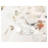 pr silver tone earrings with white bead on each;