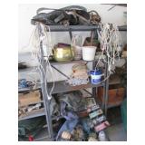 metal shelf,horse tack,cords,lights & items on it