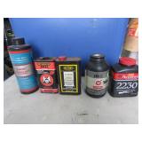 5 partial jugs of gun powder