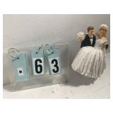 Groom carrying bride cake topper