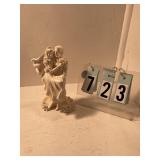 Groom holding bride wedding topper