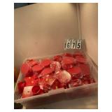 Tote of red grad hats