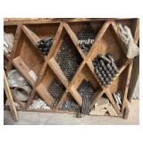 Assortment of nuts and bolts, including rack