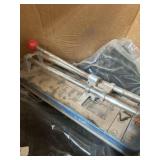 black vehicle floor mats and manual tile cutter