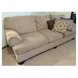 Beige Cloth Sofa Featuring Rolled Arms