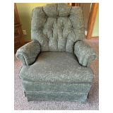 Green upholstered swivel rocking chair