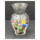Clear glass vase, half full of marbles, 7in tall