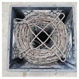 Roll of Vintage Barbed Wire in Black Plastic Crate