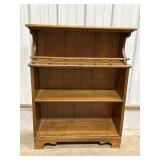 Wood bookshelf w/decorative rail on top shelf,