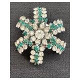 Emerald green and clear rhinestones starburst pin