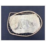 Handcrafted decorative wolf drawing on a tan hide