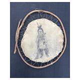 Handcrafted decorative child drawing on a tan hide