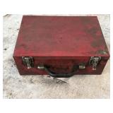 Red metal utility or tool box.  Top is slightly