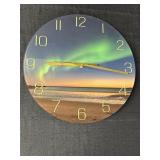 Round glass wall clock w/northern lights over a