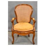 Louis XV style cherry stained caned armchair