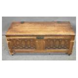 Carved pine blanket chest on casters