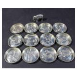 12 Astrological motif sterling silver dishes;