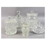 4 crystal and glass covered jars;