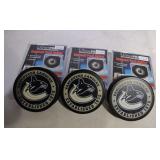3 Vancouver Canucks hockey puck holders