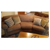 Flexsteel upholstered curved couch with 4 pillows