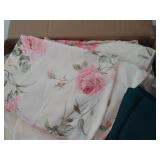 large box of tableclothes and placemats