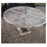 white grate table (by fire pit)