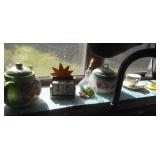 contents of kitchen window sill - teapots, candle contents of kitchen window sill - teapots, candle