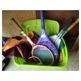 green tote of tennis raquets, bird feeders and green tote of tennis raquets, bird feeders and