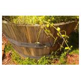 half wine barrell planter (by house inside fence)