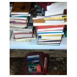 lot of books - 2 larger stacks and 1 small tote