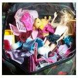 Barbie dolls, furniture, and clothes in travel bag