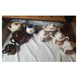 8 tea pots including a nesting tea pot and cup,