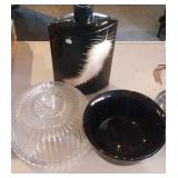 Black bowl, black vase with white feather and