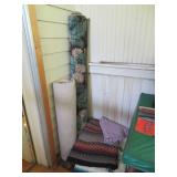 PILE OF THROW RUGS  AREA RUG IN CORNER