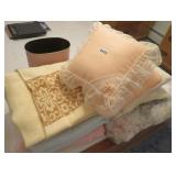 pile of blankets, pillows, comforter, waste can