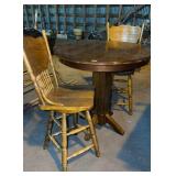 High top bar table with two oak press back,