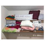 Group of blankets, throws, pillows; also includes
