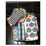 Box of kitchen towels, oven mitts, etc.; some