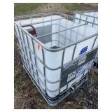 Plastic tote and contents including garden hose