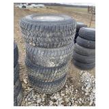 Four tires and rims 12 X 16.5 8 lug, tag 1880