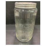 SELLERS GLASS RIBBED JAR WITH ORIGINAL LID -7 3/4"