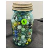 BLUE BALL JAR FULL OF GLASS MARBLES
