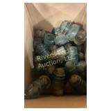 Box full of glass insulators of various sizes and
