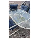 Patio table with four chairs and cushions