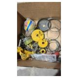 Box of hole saws and hose clamps