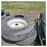 Three 24.5' truck tires two on rims