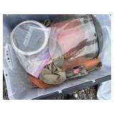 Tote full of welding clothing helmet and blankets