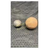 Two antique cannon balls ranging from 2'-5'