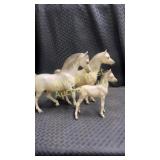 Three Breyer horse figurines. Including a mare,