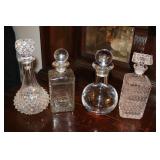 4 Decanters one is signed on the bottom